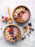 Açaí bowl with banana slices, berries, and granola
